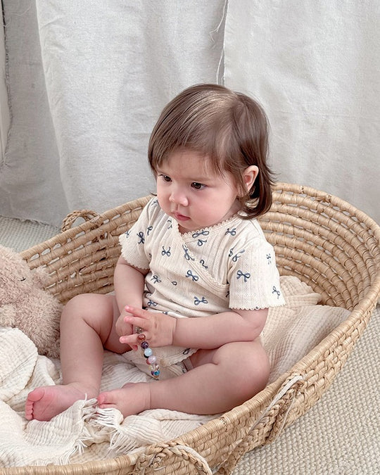 前開きアイレットリボンロンパース