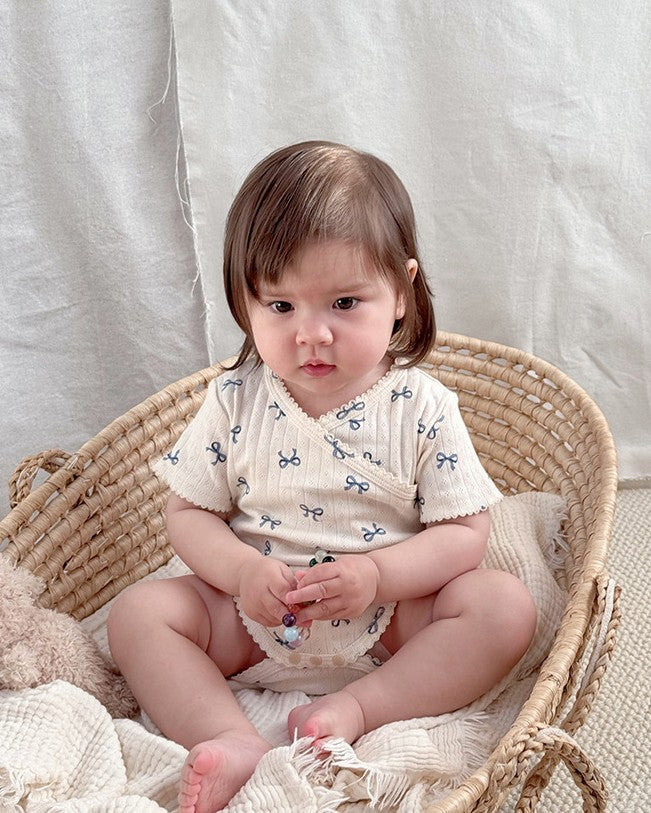 前開きアイレットリボンロンパース